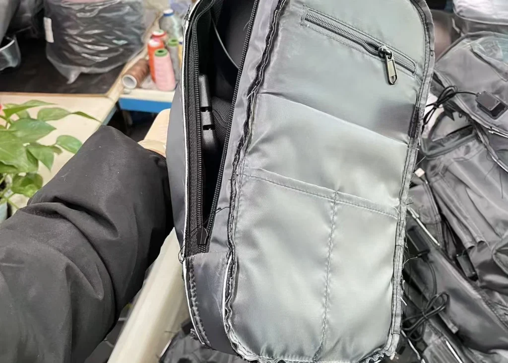 Custom bag interior construction being reviewed in a production workshop