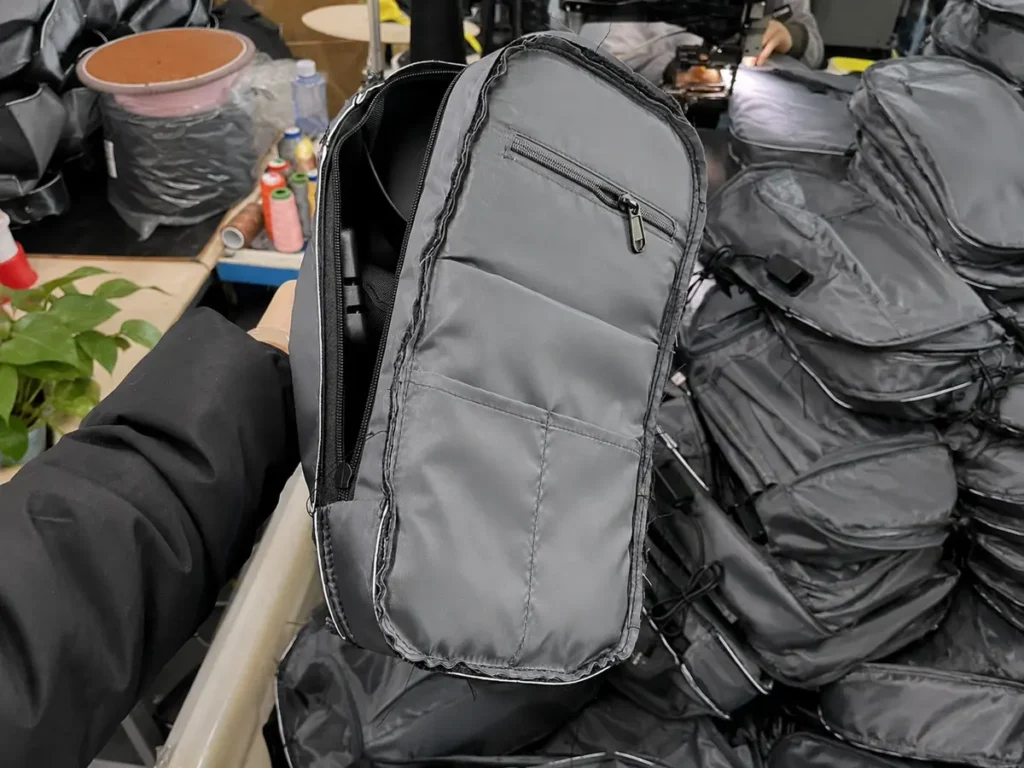 Open shoulder bag showing its lining and internal pocket construction